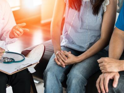 Couple talking with doctor